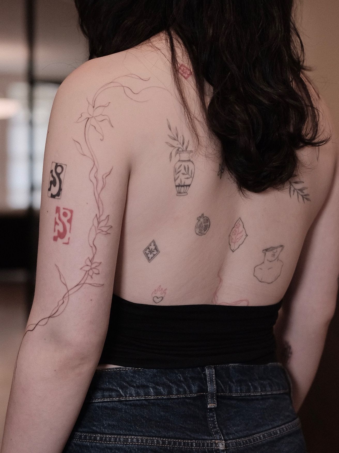 Back with a long botanical vine and small red and black flash pieces