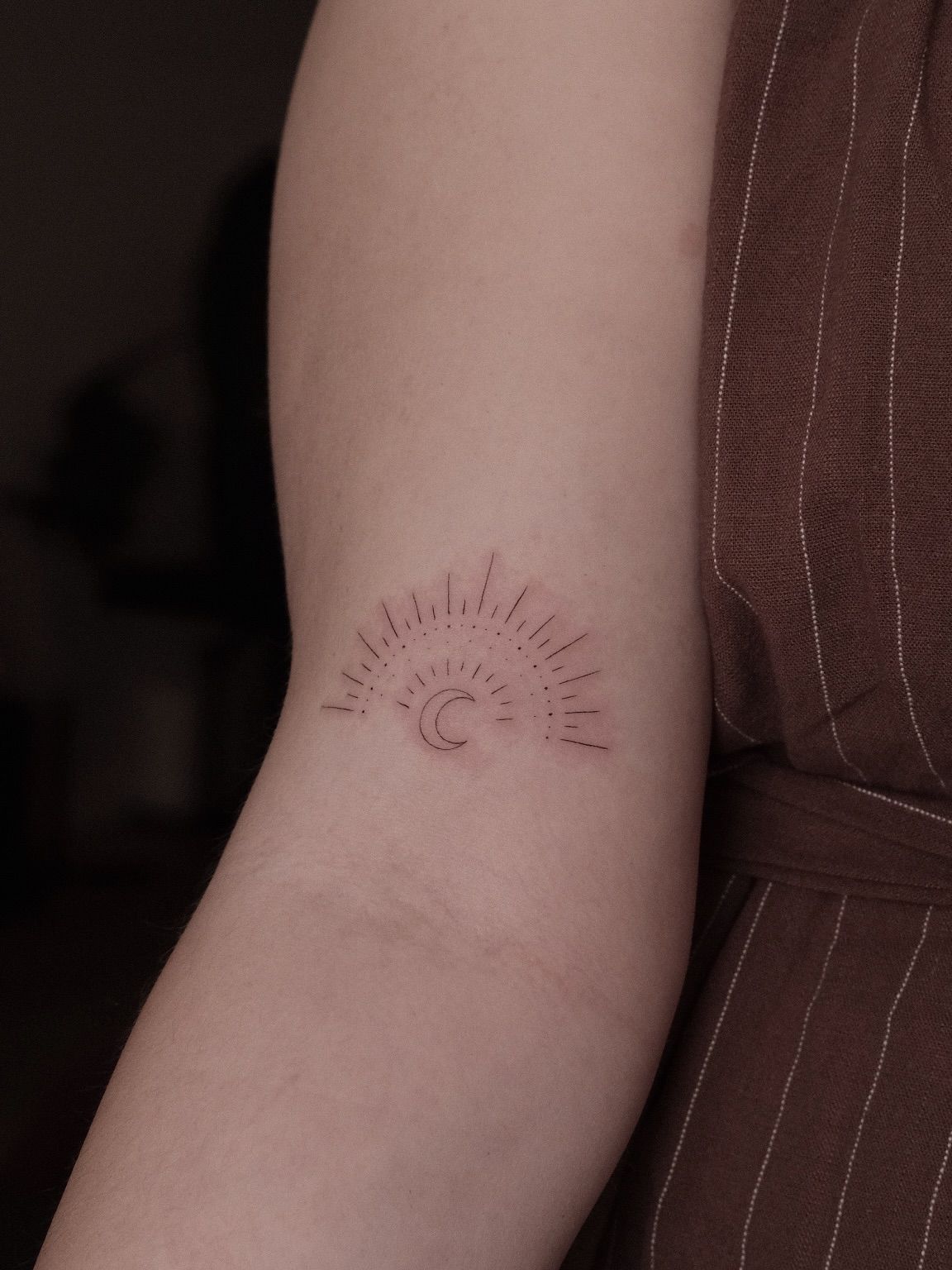Sun and crescent moon in red ink on the inner arm