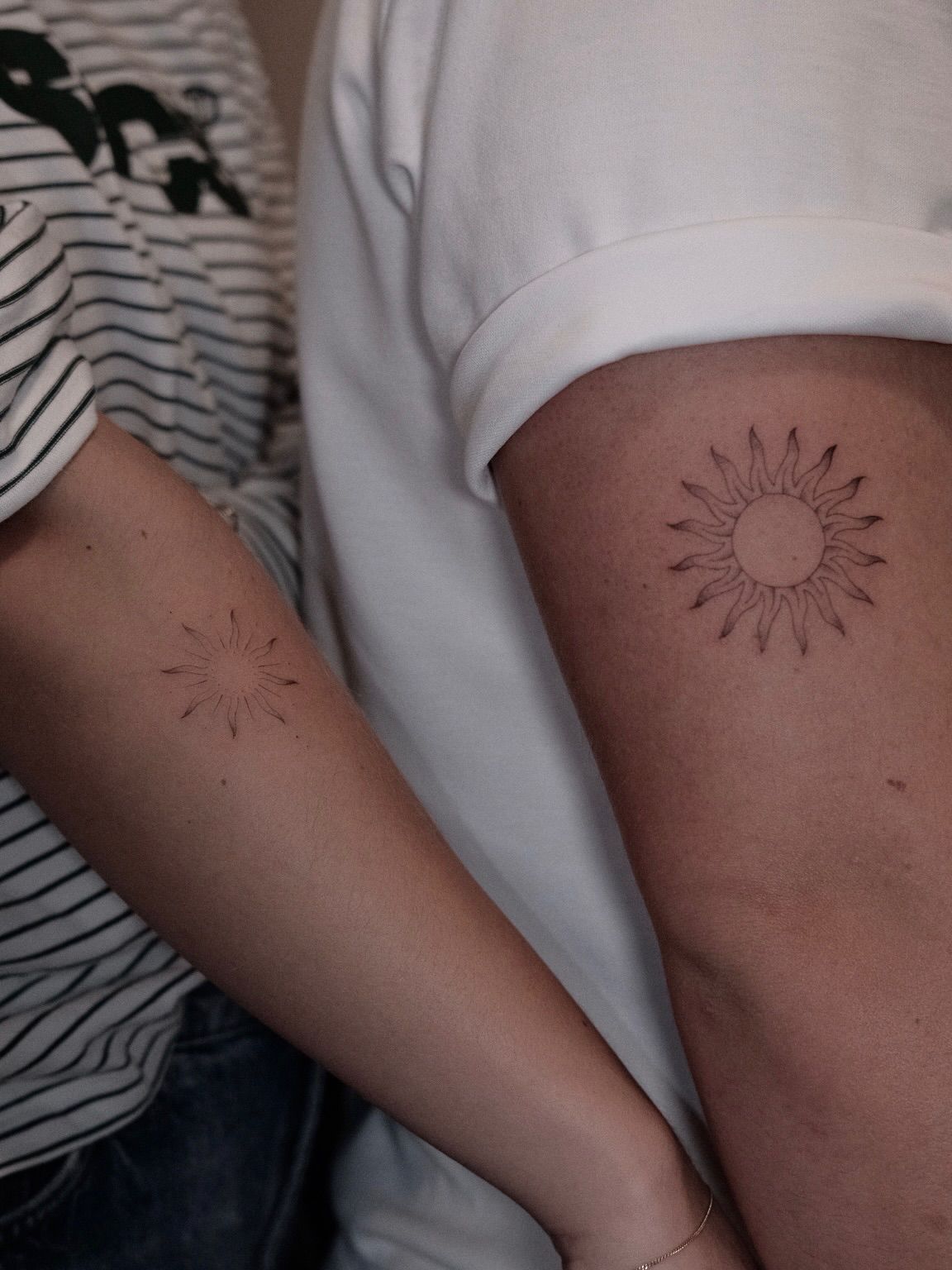 Two arms with matching fine line suns